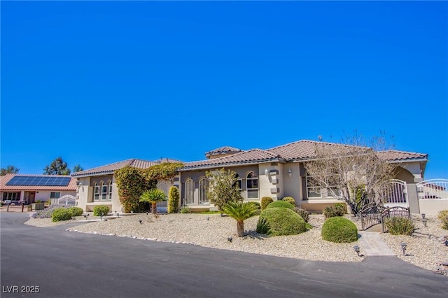 mediterranean / spanish-style house with solar panels