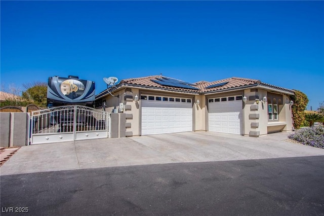 view of front of property with a garage and solar panels