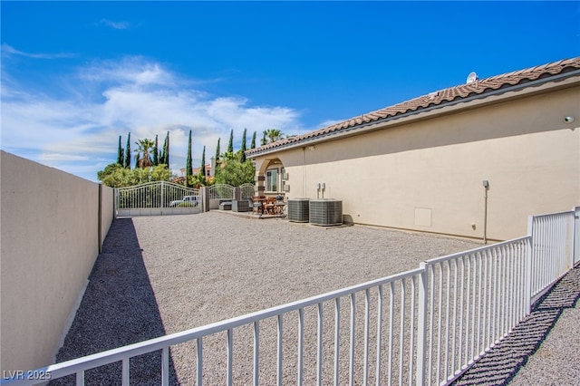 view of yard with central AC unit and a patio