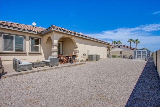 rear view of house with a patio and a storage unit