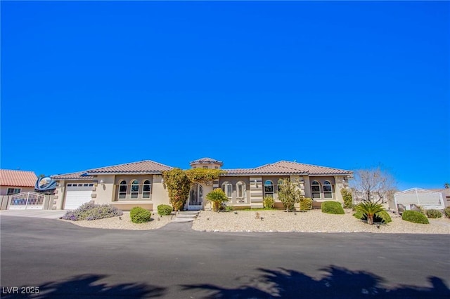 mediterranean / spanish-style home with a garage