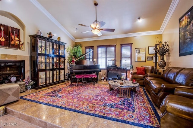 living room with a premium fireplace, vaulted ceiling, ceiling fan, and crown molding