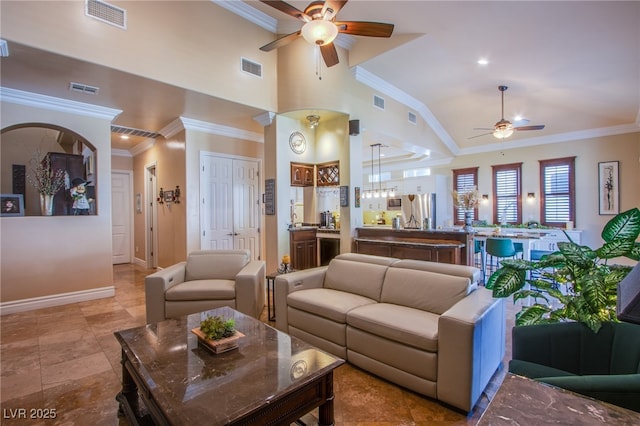 living room with vaulted ceiling, ceiling fan, and ornamental molding