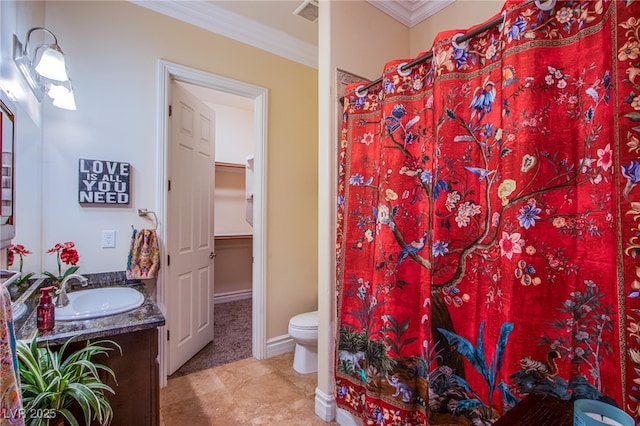 bathroom with ornamental molding, toilet, and vanity