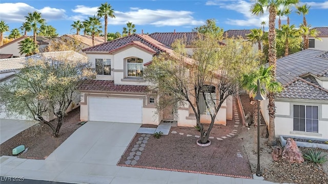 mediterranean / spanish-style home with a garage