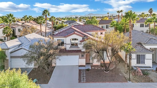 view of front of property featuring a mountain view and a garage