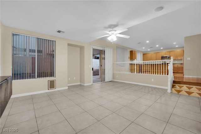 tiled spare room with ceiling fan