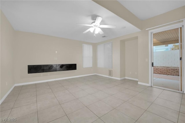 unfurnished living room featuring ceiling fan and light tile patterned flooring