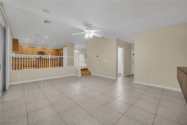 unfurnished living room with ceiling fan and light tile patterned flooring