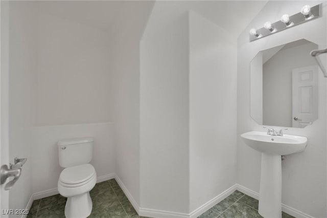 bathroom featuring tile patterned floors, vaulted ceiling, and toilet