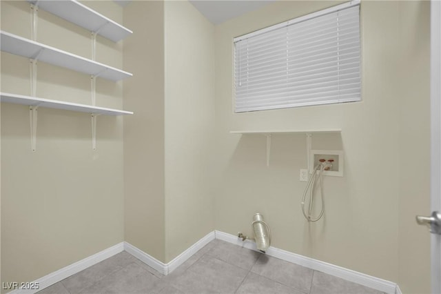 laundry area with hookup for a washing machine, light tile patterned floors, and gas dryer hookup