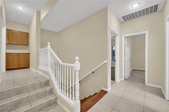 stairway with tile patterned floors