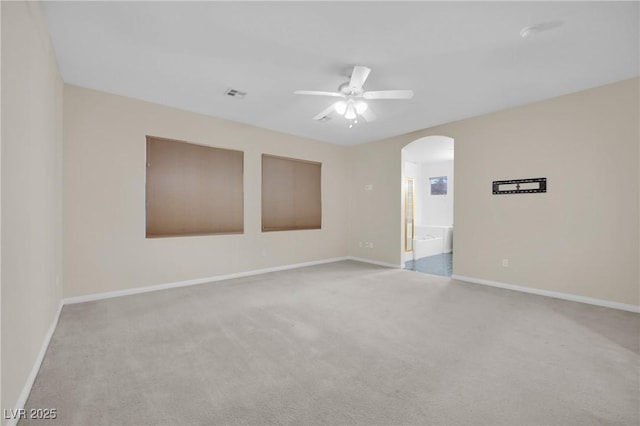 empty room with light colored carpet and ceiling fan