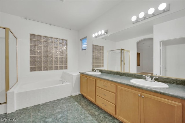 bathroom featuring vanity and shower with separate bathtub