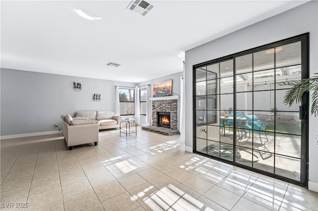 tiled living room featuring a fireplace