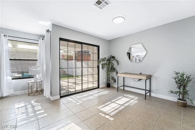 doorway to outside featuring tile patterned flooring