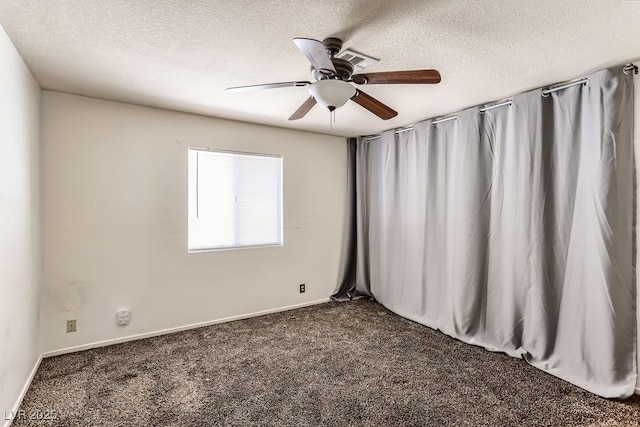 carpeted spare room with a textured ceiling and ceiling fan