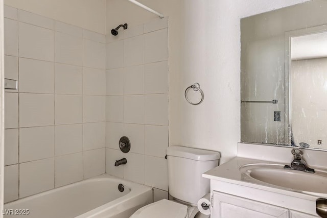 full bathroom featuring toilet, vanity, and tiled shower / bath