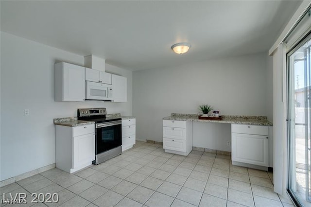 kitchen featuring electric stove, light stone countertops, and white cabinets