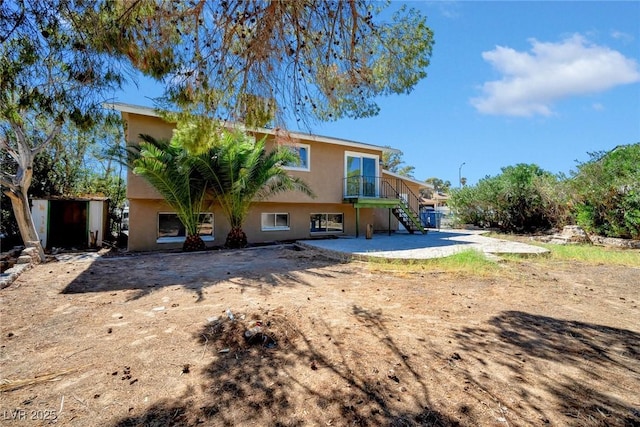 rear view of property with a balcony