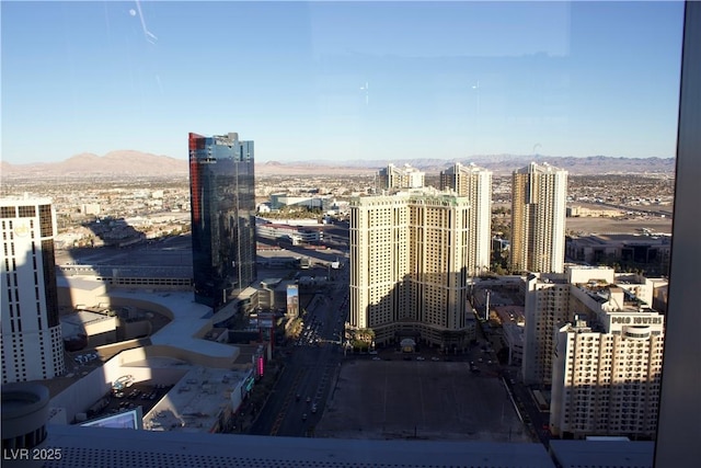 property's view of city with a mountain view