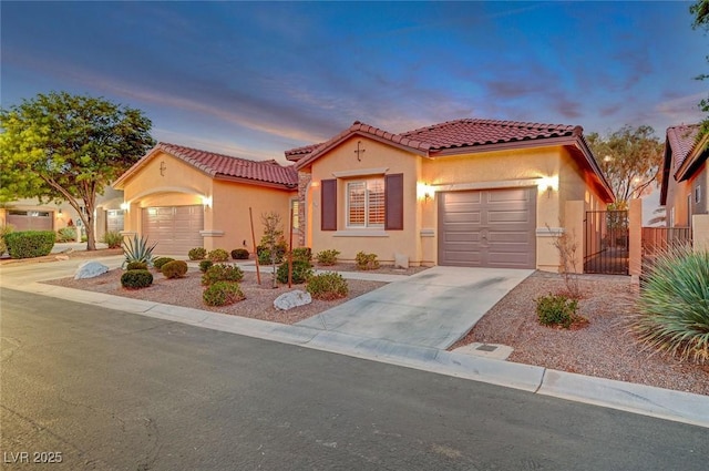 mediterranean / spanish-style home with a garage