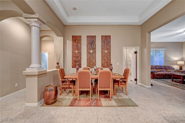 dining area with ceiling fan and ornate columns