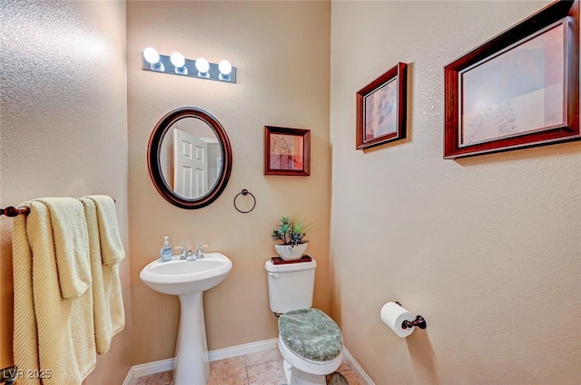 bathroom featuring tile patterned flooring and toilet