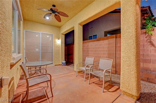 view of patio featuring ceiling fan