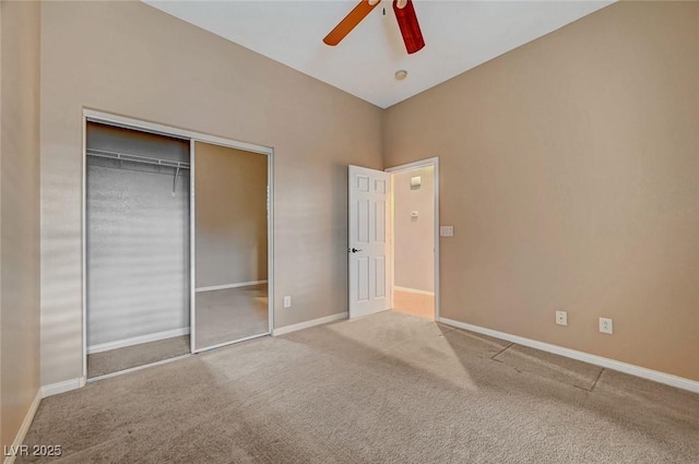 unfurnished bedroom featuring carpet, ceiling fan, and a closet