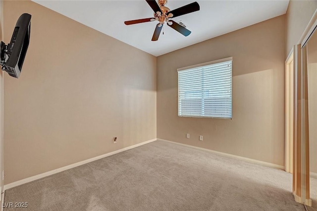 unfurnished bedroom with ceiling fan and light colored carpet