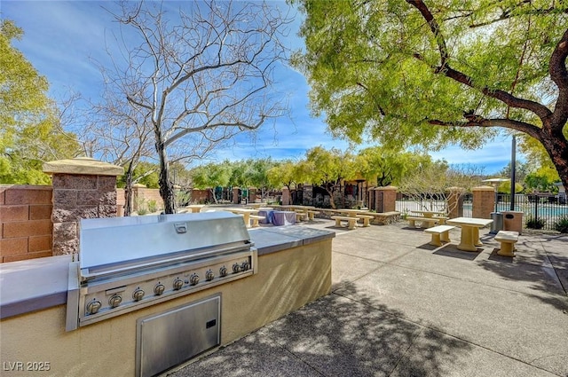 view of patio with an outdoor kitchen and grilling area