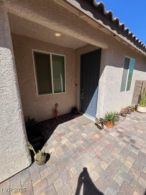 entrance to property with a patio area