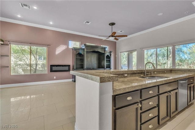 kitchen featuring light stone countertops, sink, plenty of natural light, and ornamental molding