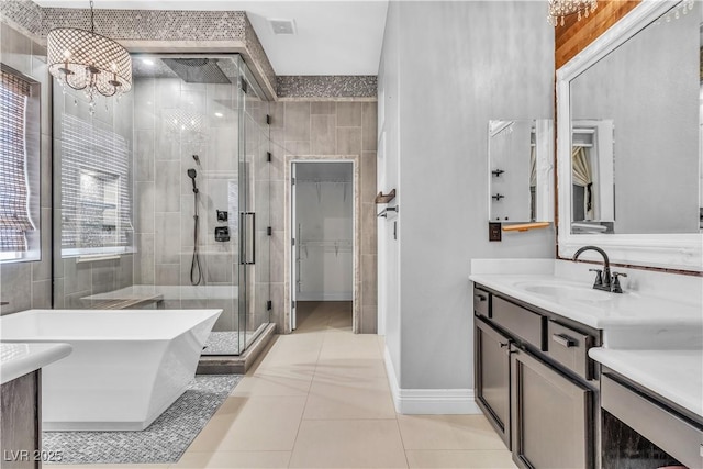 bathroom featuring vanity, tile patterned floors, separate shower and tub, and an inviting chandelier