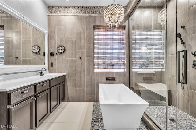 bathroom featuring vanity, tile walls, independent shower and bath, and an inviting chandelier