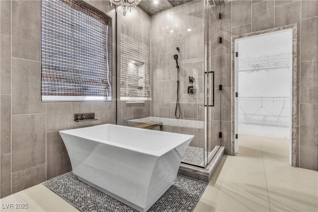 bathroom featuring independent shower and bath and tile walls