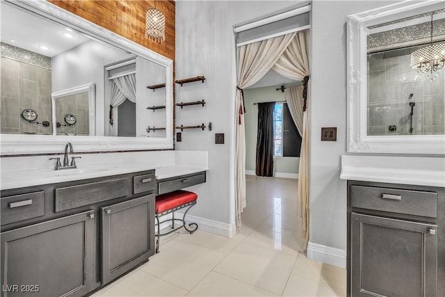 bathroom with tile patterned flooring, vanity, and tiled shower