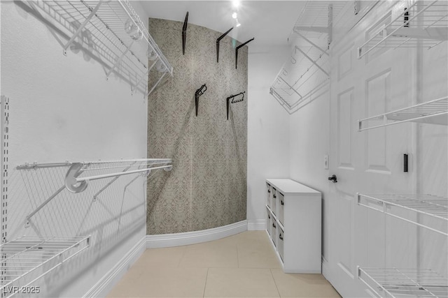 spacious closet with light tile patterned floors