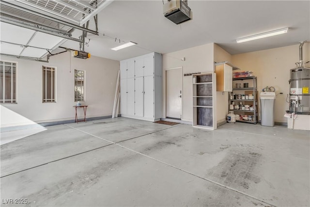 garage with strapped water heater and a garage door opener