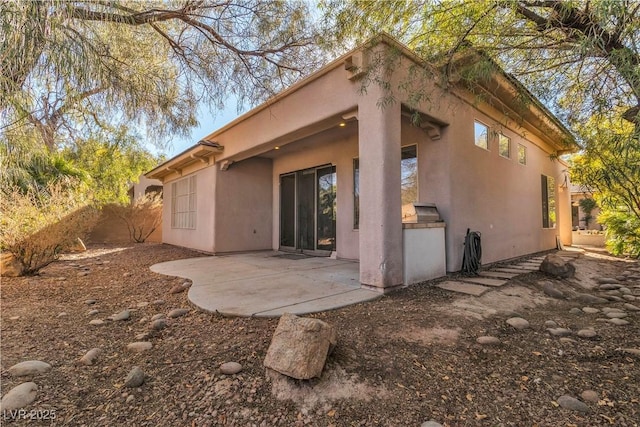 back of property featuring a patio area