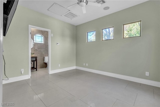 tiled empty room with ceiling fan