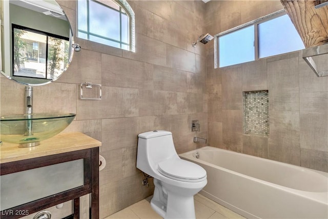 full bathroom featuring bathtub / shower combination, vanity, tile walls, tile patterned flooring, and toilet