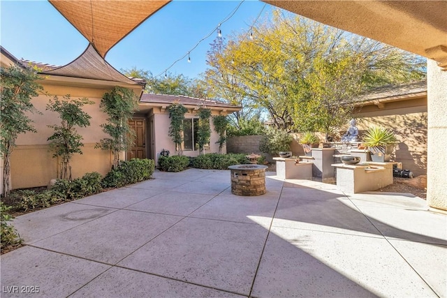 view of patio / terrace with area for grilling and a fire pit