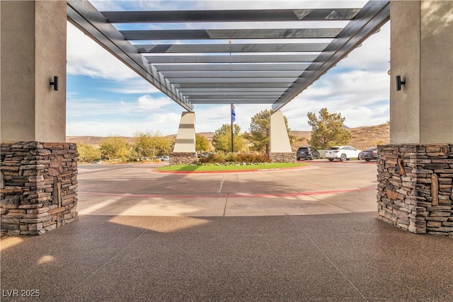 view of patio featuring a mountain view and a carport