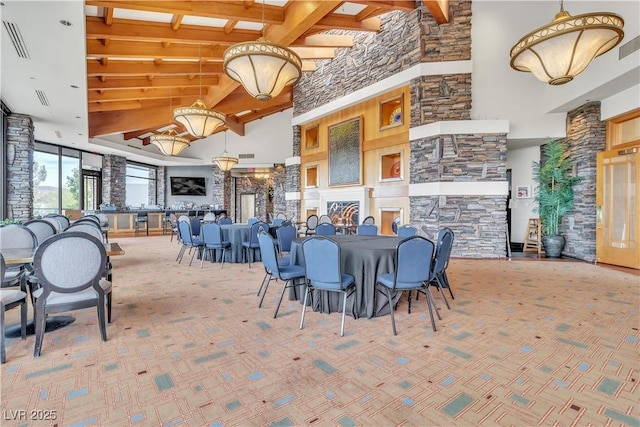 carpeted dining space featuring beamed ceiling and a towering ceiling