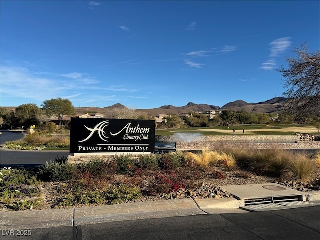 community / neighborhood sign featuring a water and mountain view