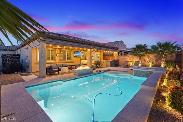 pool at dusk featuring an outdoor living space, an outdoor kitchen, exterior bar, an in ground hot tub, and a patio