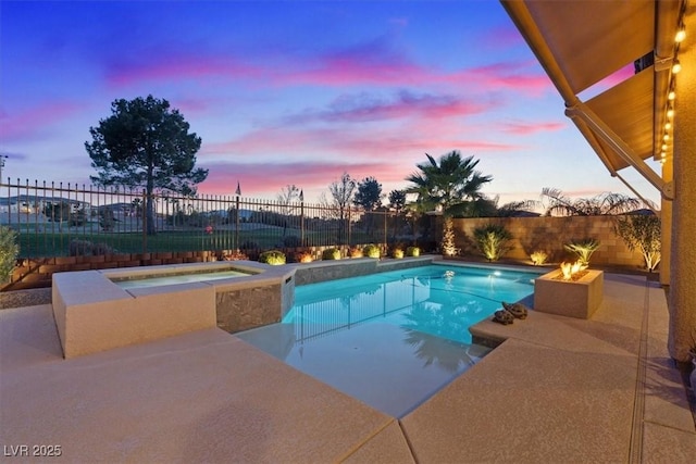 pool at dusk with an in ground hot tub