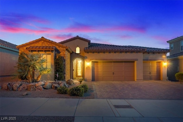 mediterranean / spanish-style house with a garage